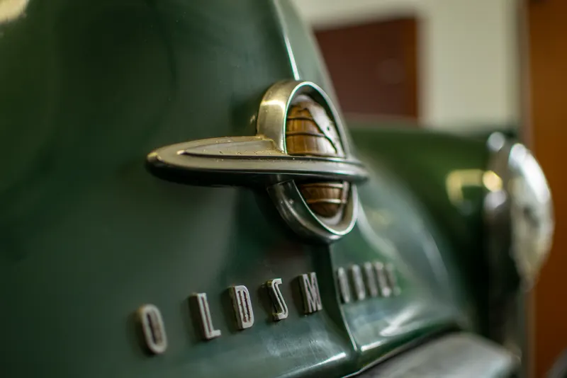 Vintage Oldsmobile hood emblem at 8A's Auto in Peoria